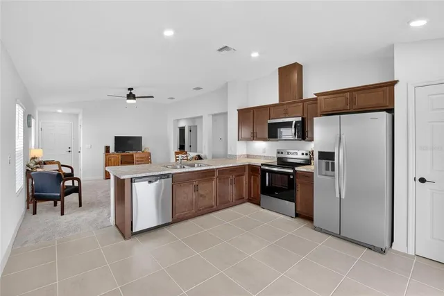 a living room with furniture and kitchen view
