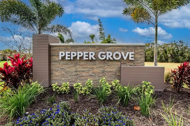 a sign that is sitting in front of flowers