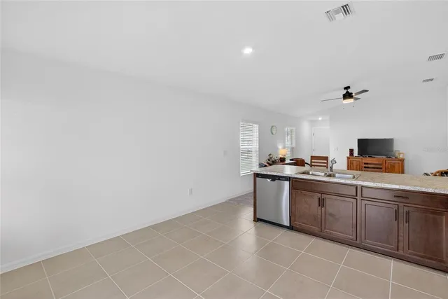 a view of a hallway with closet and wooden floor