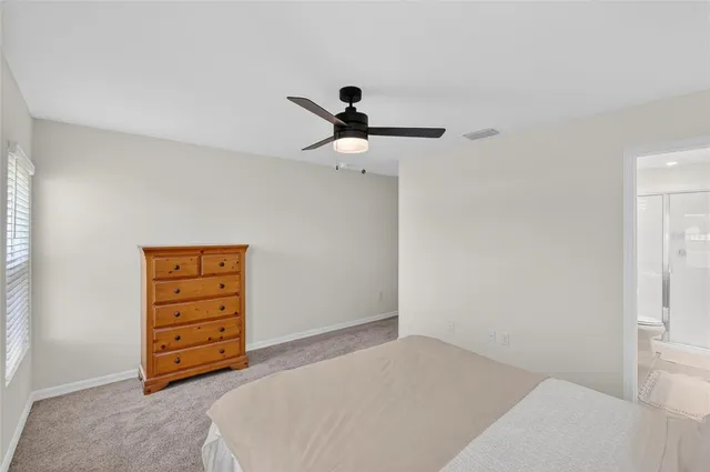 a bathroom with a granite countertop sink a toilet a mirror and shower