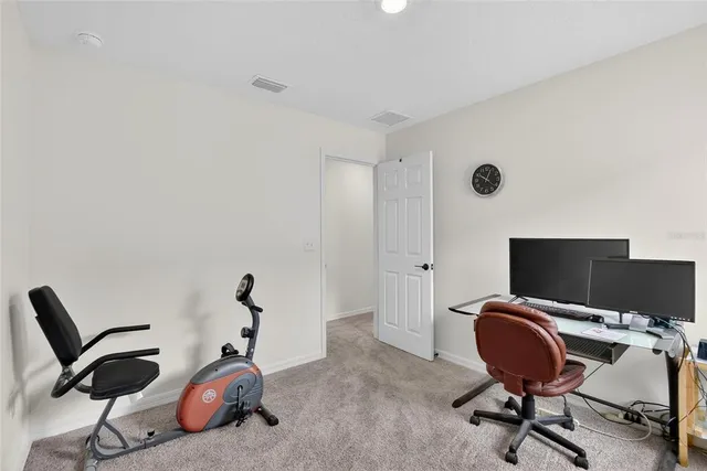 a view of a workspace with furniture and a window
