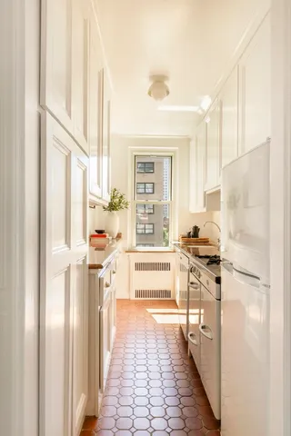a living room with furniture and a lamp