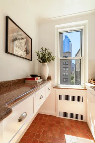 a living room with a dining table and chairs