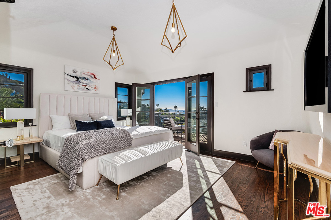 2426 Chislehurst Drive Los Angeles, CA 90027 - Photo 12 of 43 a living room with a bed mirror furniture and a flat screen tv