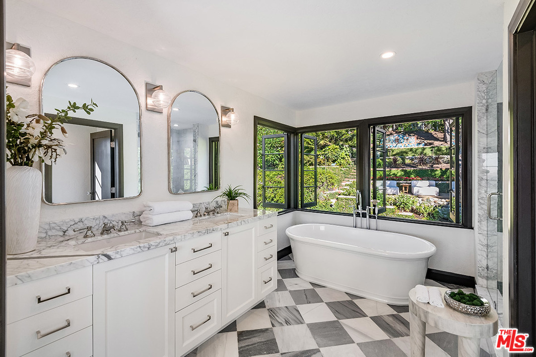 2426 Chislehurst Drive Los Angeles, CA 90027 - Photo 14 of 43 a bathroom with a double vanity sink a toilet and a window