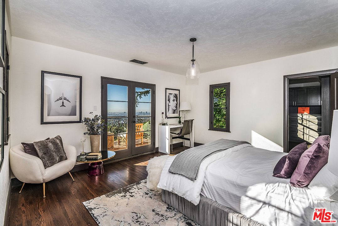 2426 Chislehurst Drive Los Angeles, CA 90027 - Photo 15 of 43 a bedroom with a large bed a couch and a window