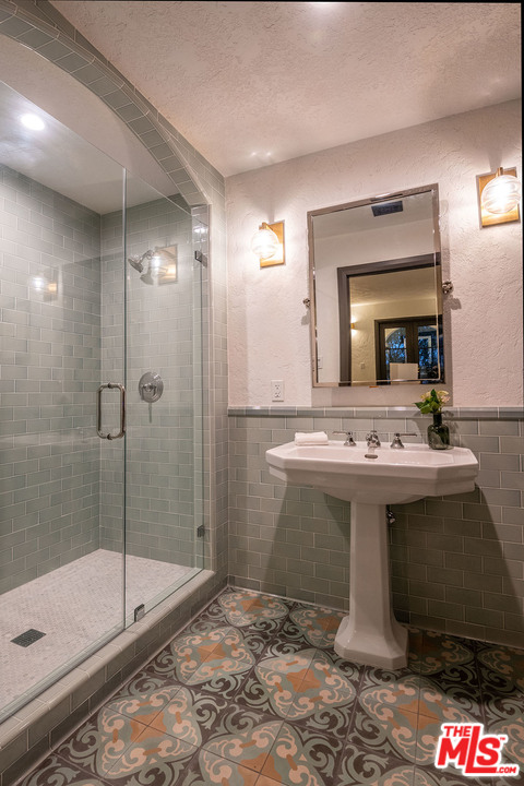 2426 Chislehurst Drive Los Angeles, CA 90027 - Photo 22 of 43 a view of a bathroom with a sink and mirror
