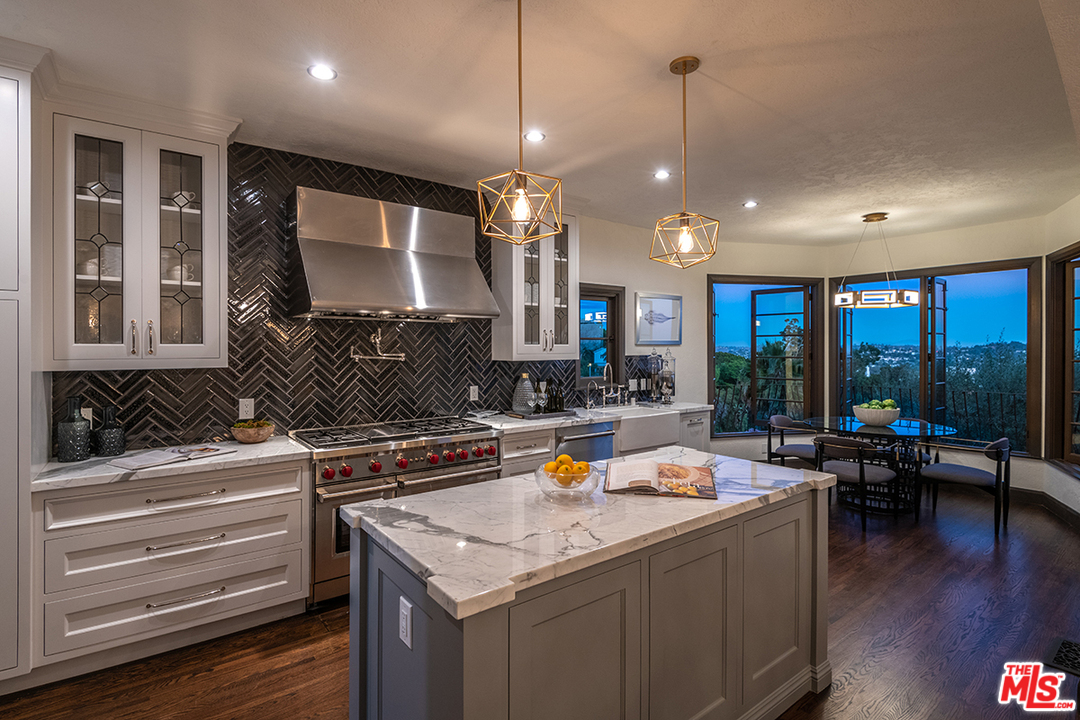 2426 Chislehurst Drive Los Angeles, CA 90027 - Photo 35 of 43 a kitchen with stainless steel appliances granite countertop a stove and a view of living room