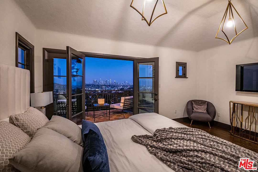 2426 Chislehurst Drive Los Angeles, CA 90027 - Photo 38 of 43 a bedroom with furniture and a chandelier