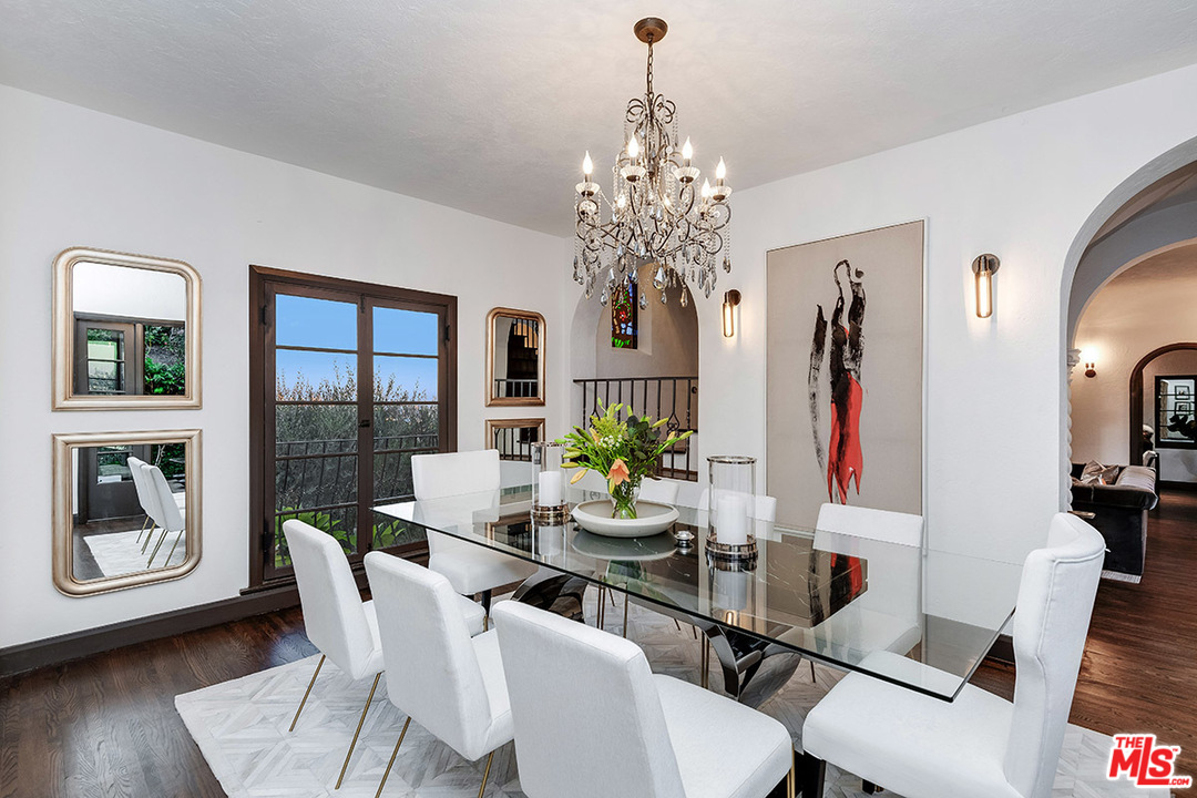 2426 Chislehurst Drive Los Angeles, CA 90027 - Photo 9 of 43 a view of a dining room with furniture a chandelier and wooden floor