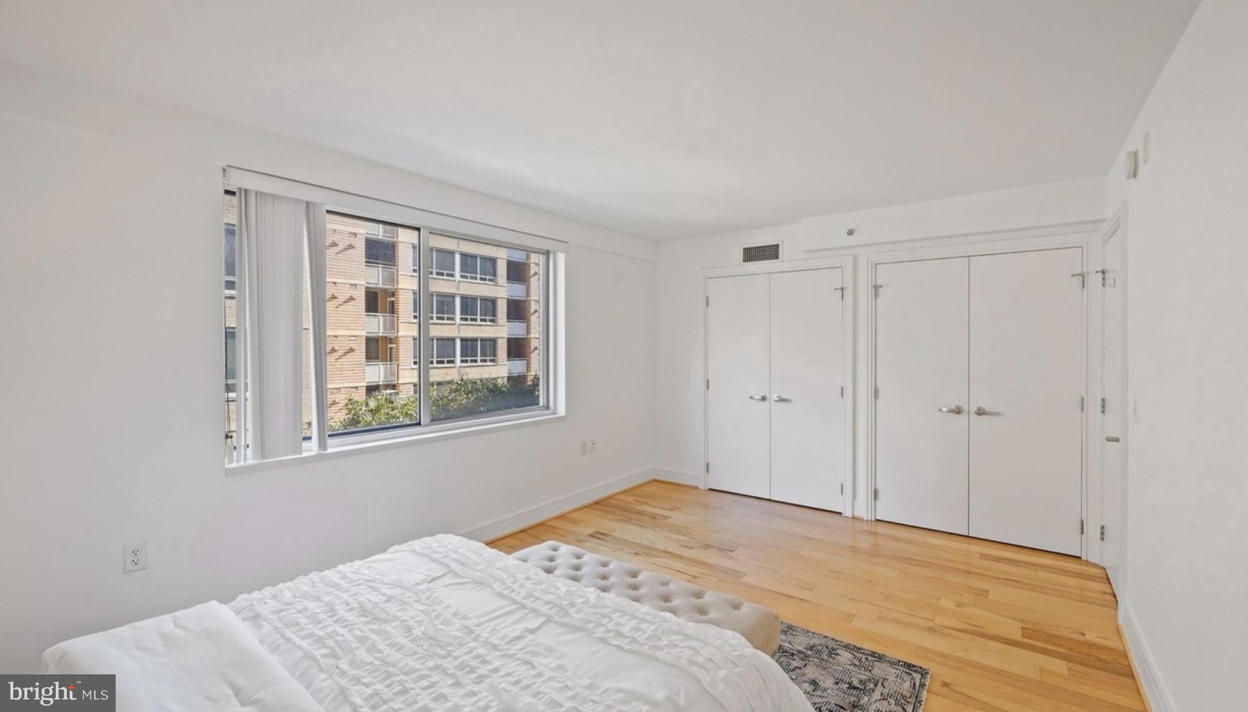 800 4th Street Southwest, Unit N120 Washington, DC 20024 - Photo 14 of 30 a bedroom with a bed and a window