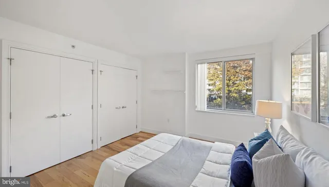 a bedroom with a bed and a window