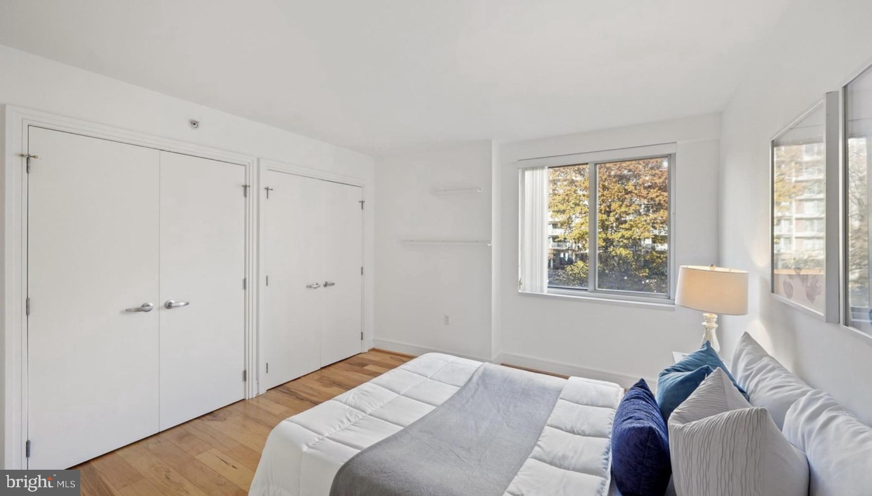800 4th Street Southwest, Unit N120 Washington, DC 20024 - Photo 15 of 30 a bedroom with a bed and a window