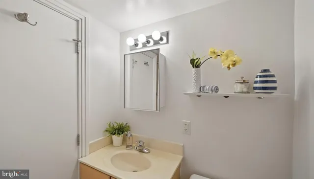 a bathroom with a sink a mirror and a window