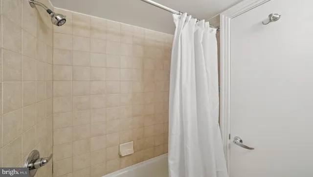 a bathroom with a shower and a glass door shower