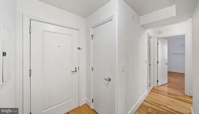 a view of a room with wooden floor