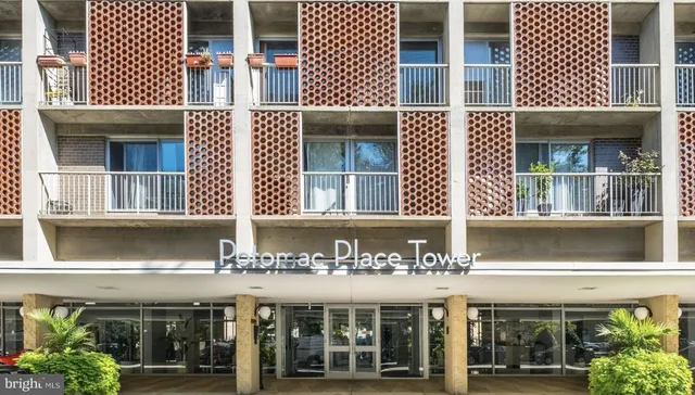 a front view of a building with glass windows and a garage