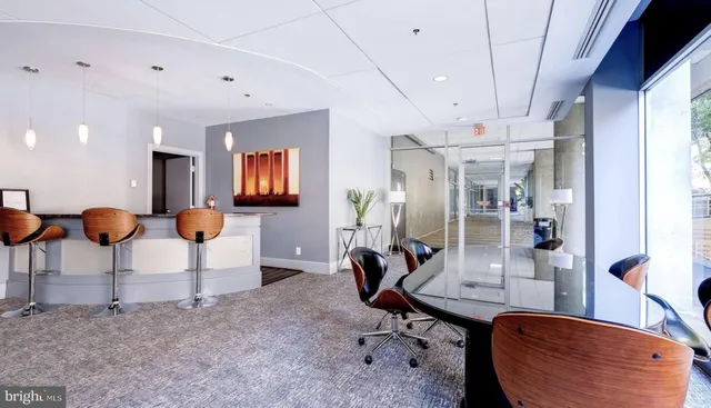 a room with lots of chairs and mirrors