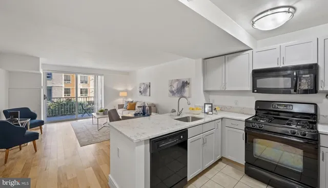 a kitchen with a sink stove and microwave