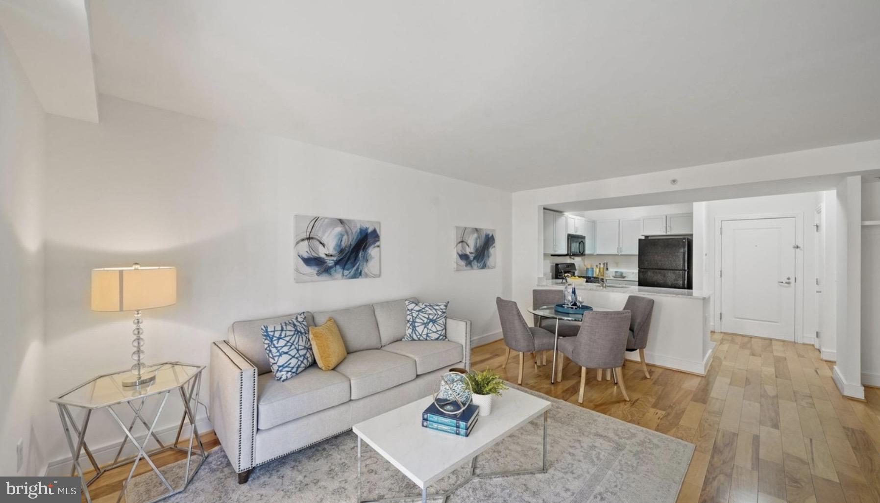 800 4th Street Southwest, Unit N120 Washington, DC 20024 - Photo 7 of 30 a living room with furniture and a flat screen tv