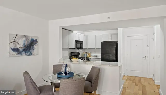 a dining room with furniture and a kitchen view