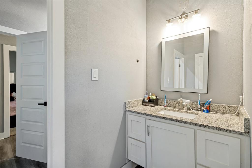 7909 Ivory Lane Dallas, TX 75216 - Photo 17 of 20 a bathroom with a sink and a mirror