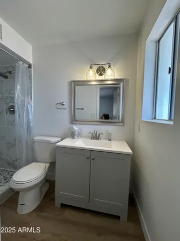 a bathroom with a sink toilet and shower