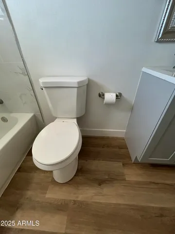 a bathroom with a toilet and a shower