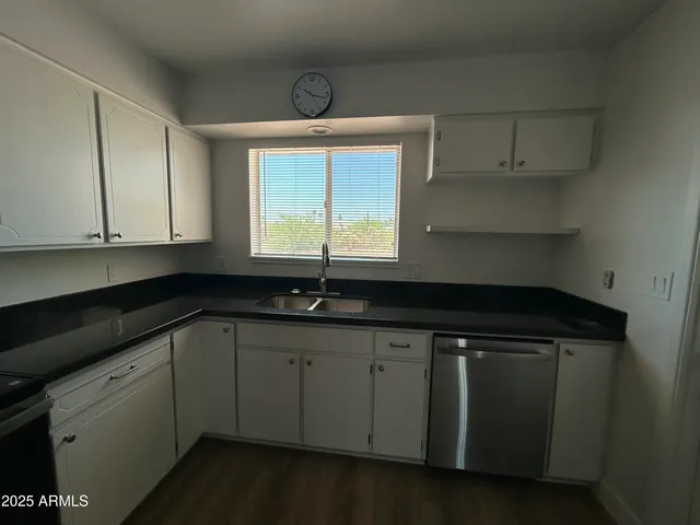 a kitchen with a sink cabinets and window