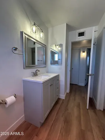 a spacious bathroom with a double vanity sink and a mirror