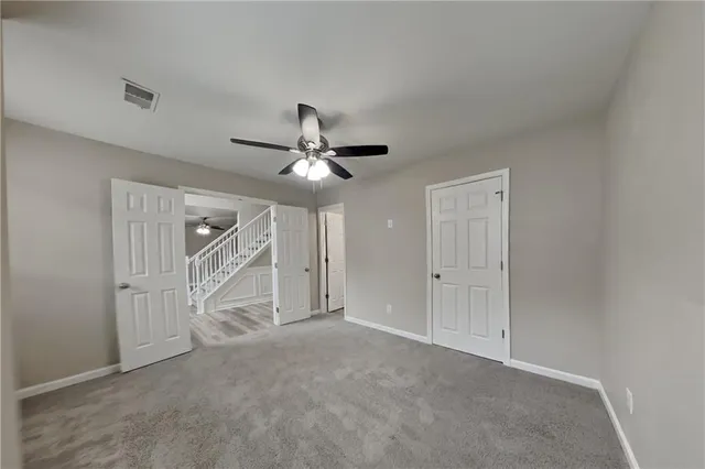 a view of a livingroom with a ceiling fan and window