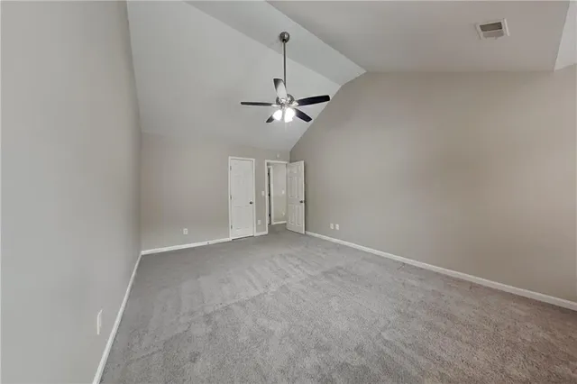 en view of a room with a ceiling fan and a window