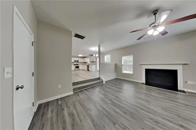 a view of a room wooden floor and fire place