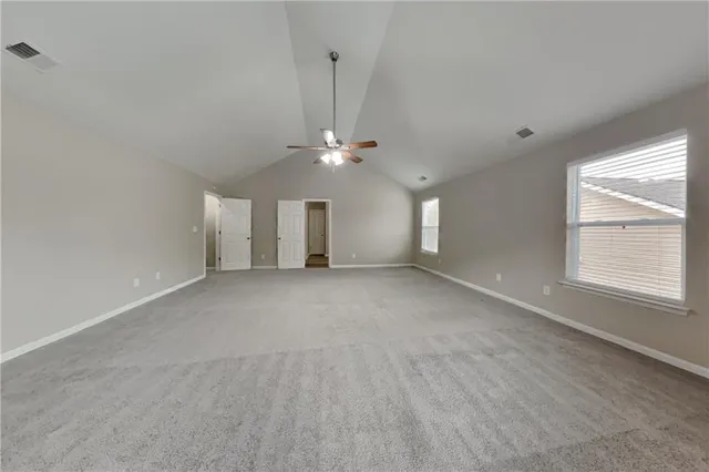 a view of a livingroom with a ceiling fan and window