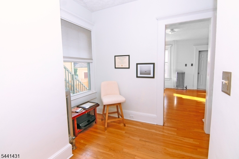 306 Springfield Avenue, Unit 1 Summit, NJ 07901 - Photo 3 of 17 a view of a room with wooden floor and furniture