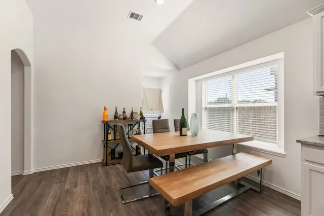 a view of a dining room with furniture and window