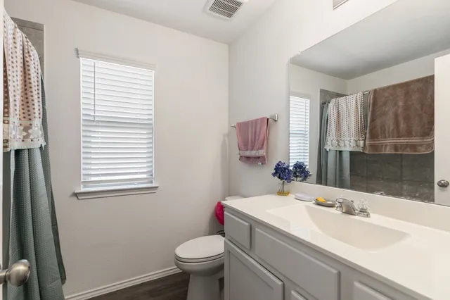 a bathroom with a sink toilet and shower