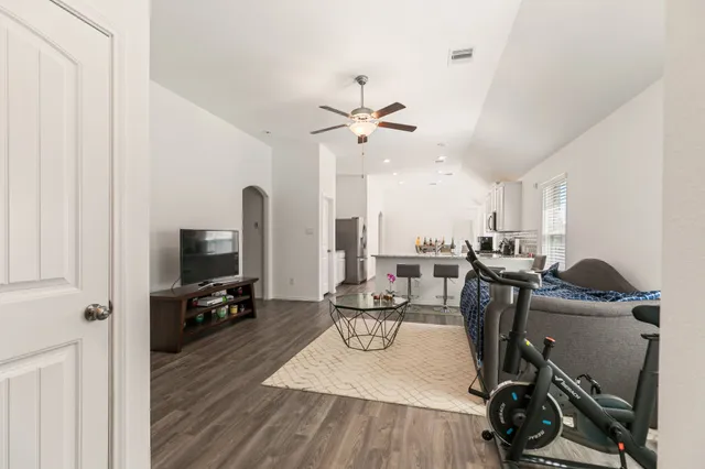 a view of a workspace with furniture and a flat screen tv