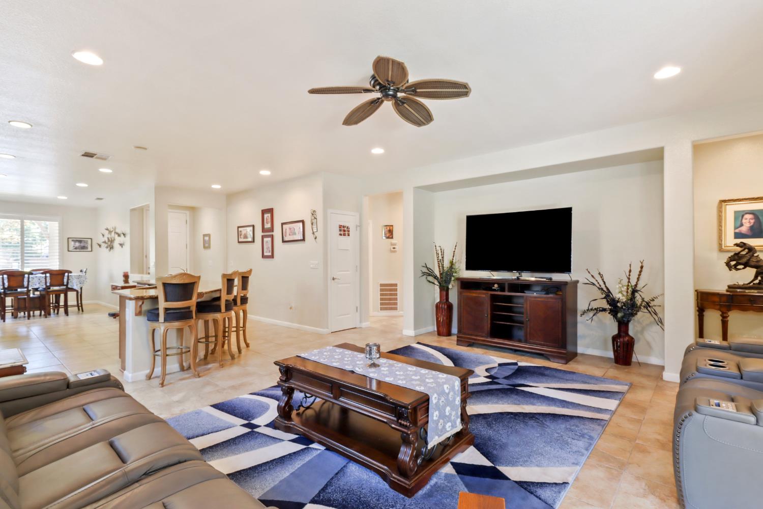 7401 Rothschild Court Elk Grove, CA 95757 - Photo 16 of 42 a living room with furniture and a flat screen tv