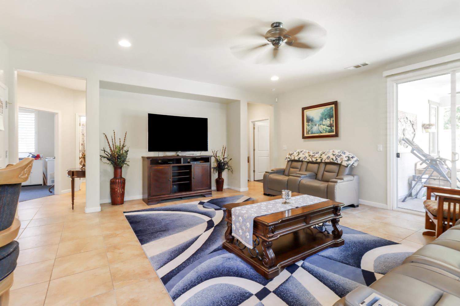 7401 Rothschild Court Elk Grove, CA 95757 - Photo 17 of 42 a living room with furniture and a flat screen tv