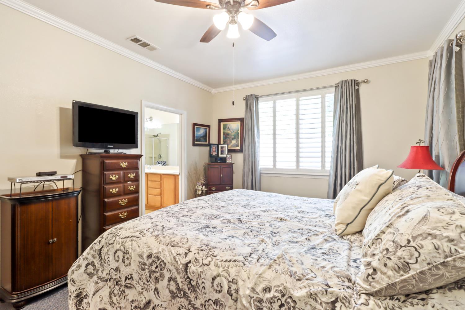 7401 Rothschild Court Elk Grove, CA 95757 - Photo 20 of 42 a bedroom with a bed and a flat screen tv