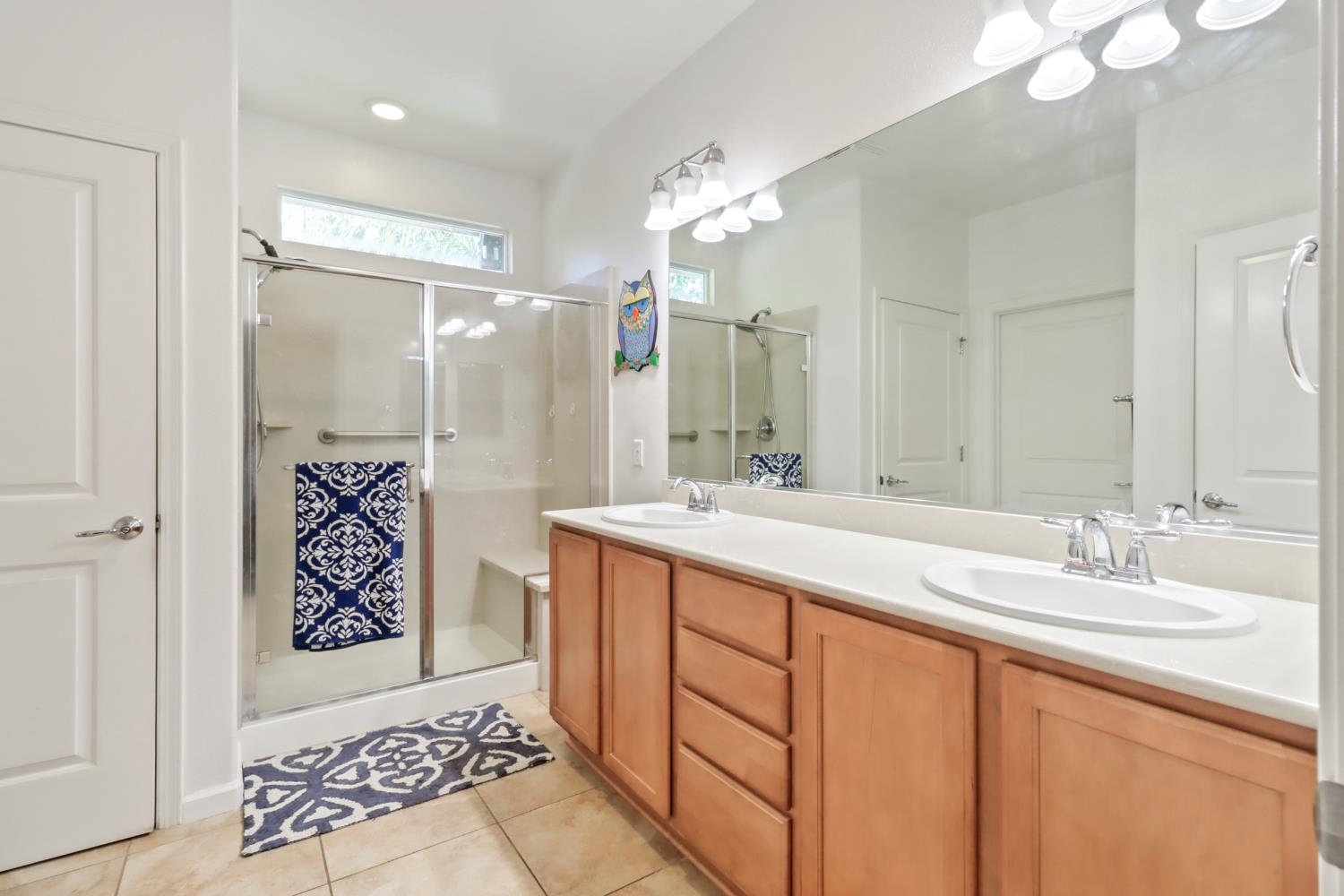 7401 Rothschild Court Elk Grove, CA 95757 - Photo 22 of 42 a spacious bathroom with a shower sink and mirror