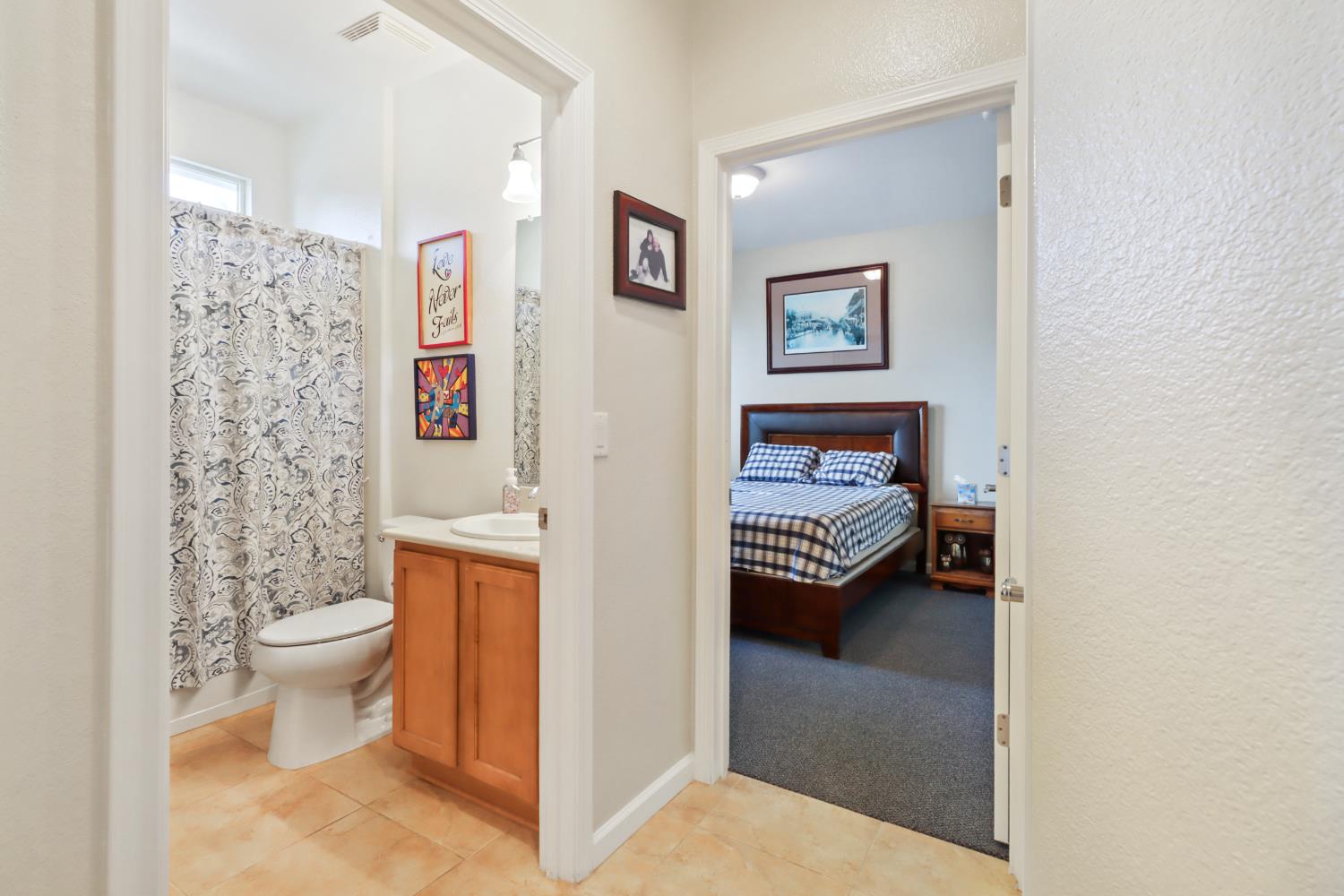 7401 Rothschild Court Elk Grove, CA 95757 - Photo 24 of 42 a en suite bathroom with a toilet and a shower curtain