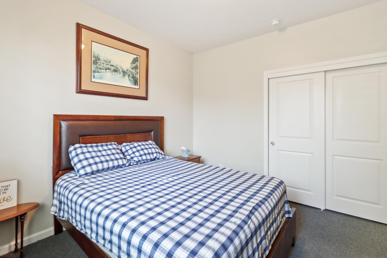 7401 Rothschild Court Elk Grove, CA 95757 - Photo 26 of 42 a bedroom with a bed and a painting on the wall