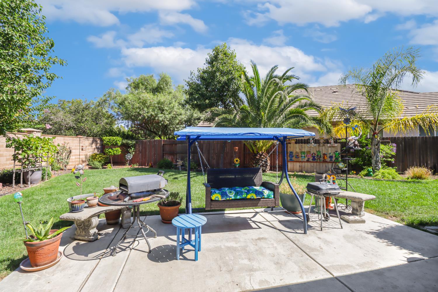 7401 Rothschild Court Elk Grove, CA 95757 - Photo 30 of 42 a view of a patio with table and chairs potted plants with wooden fence