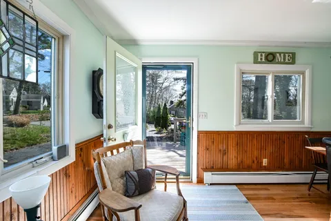 a view of a dining room with furniture window and wooden floor