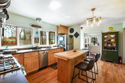 a kitchen with stainless steel appliances a sink a stove and refrigerator
