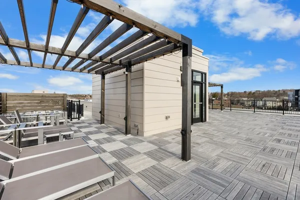 a roof deck with table and chairs