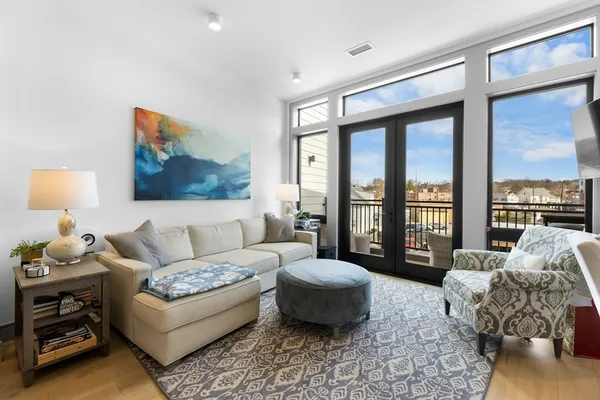 a living room with furniture and a floor to ceiling window
