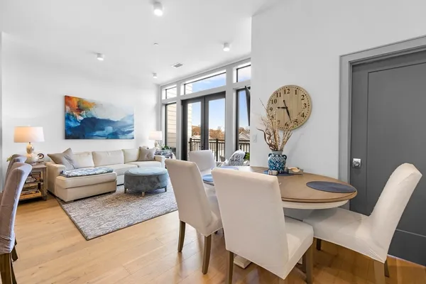 a living room with furniture a rug and a large window